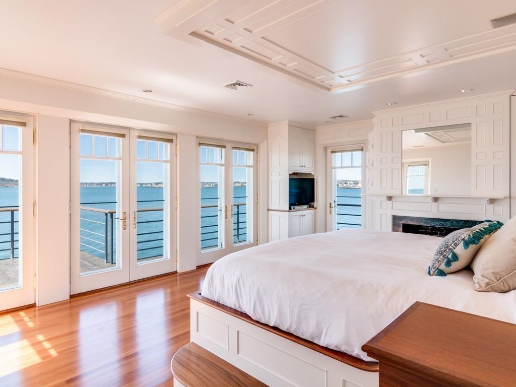 71 Eastern Point Boulevard Gloucester, MA 01930 - Photo 30 of 40 a bedroom with a large bed and a large window