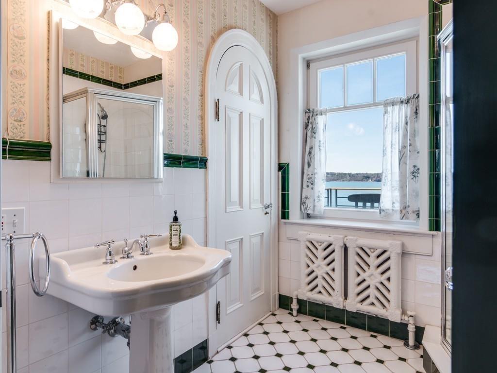 71 Eastern Point Boulevard Gloucester, MA 01930 - Photo 32 of 40 a bathroom with a sink a mirror and a shower