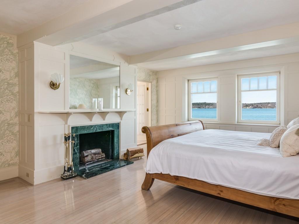 71 Eastern Point Boulevard Gloucester, MA 01930 - Photo 36 of 40 a bedroom with a bed and a fireplace