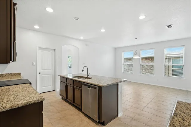 a kitchen with a sink stove and cabinets