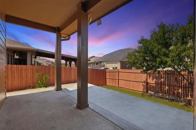 a view of a street with wooden fence