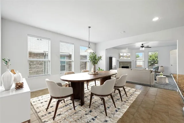 a dining room with furniture a chandelier and wooden floor