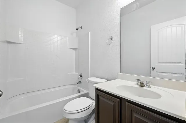 a bathroom with a sink toilet vanity and shower