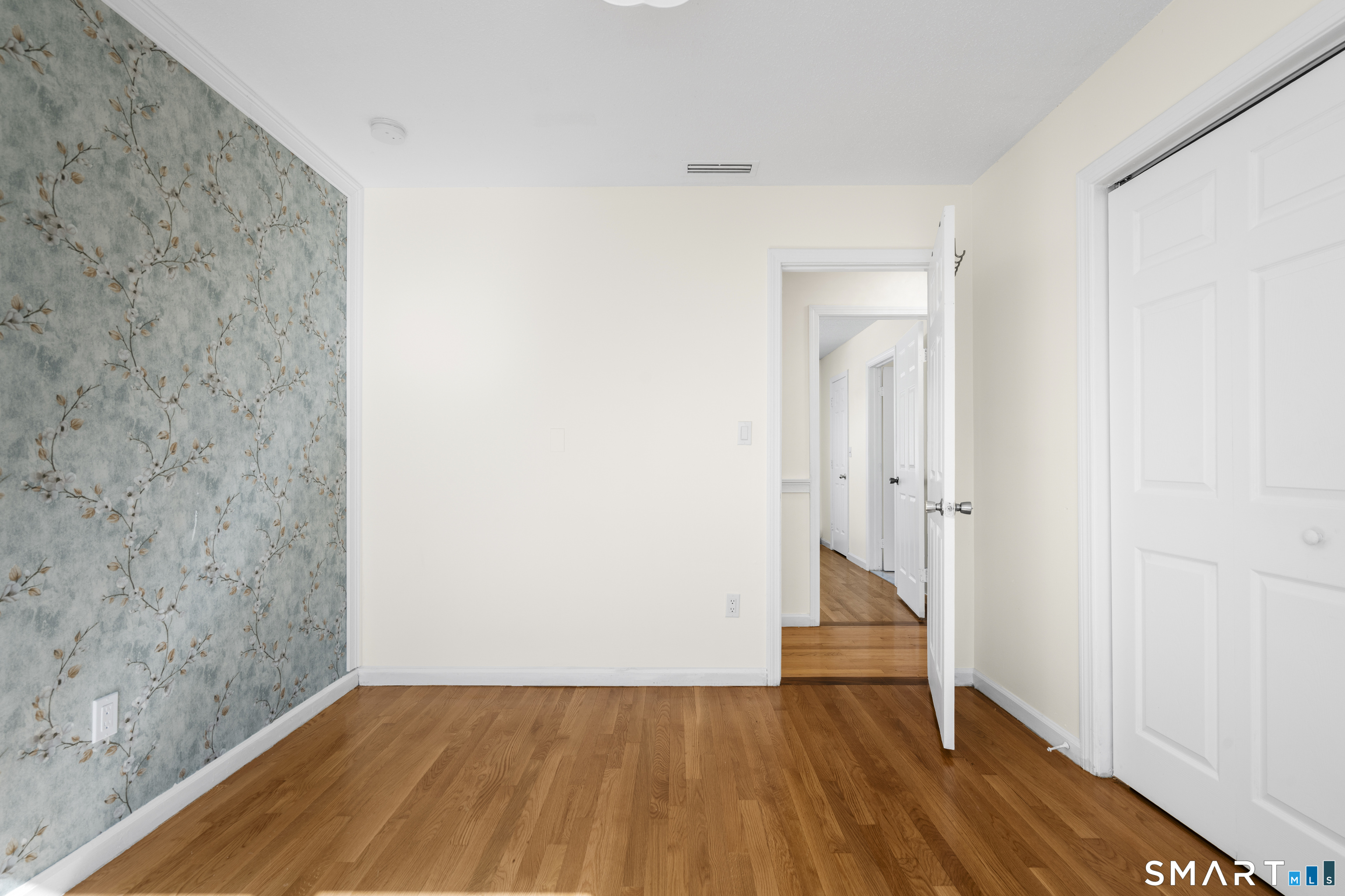 39 Joseph Lane Hamden, CT 06514 - Photo 19 of 40 a view of a room with wooden floor and a white wall
