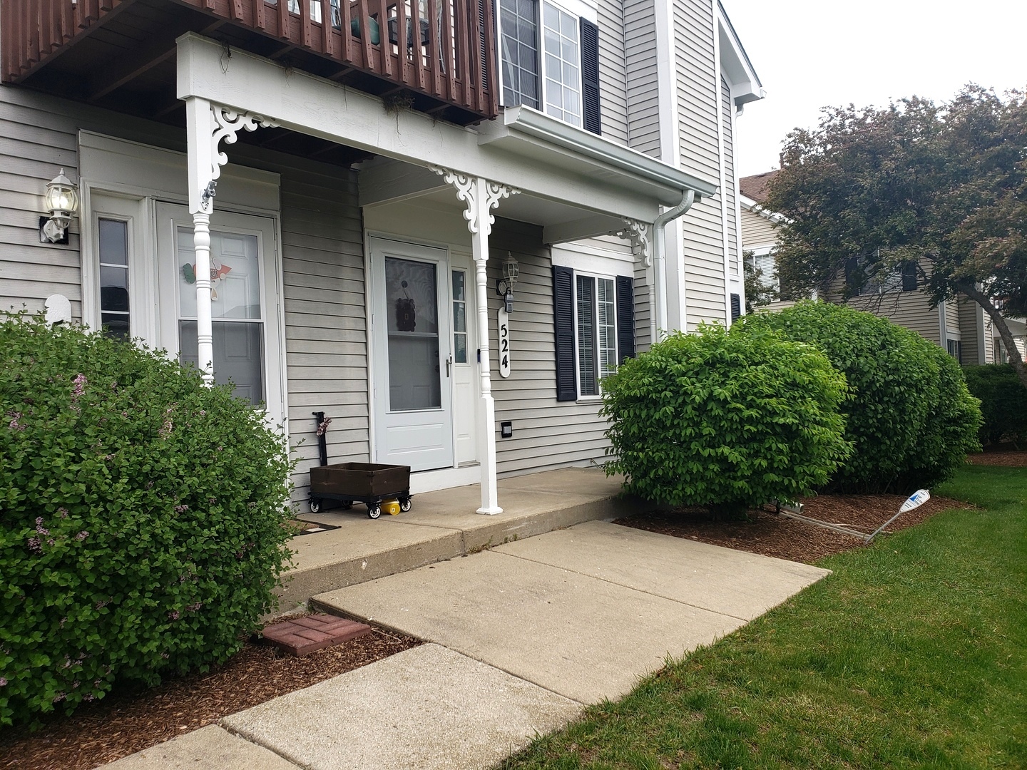 524 Sandhurst Lane South Elgin, IL 60177 - Photo 1 of 32 a view of a house with potted plants and a bench