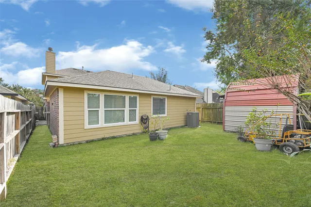 a backyard of a house with table and chairs