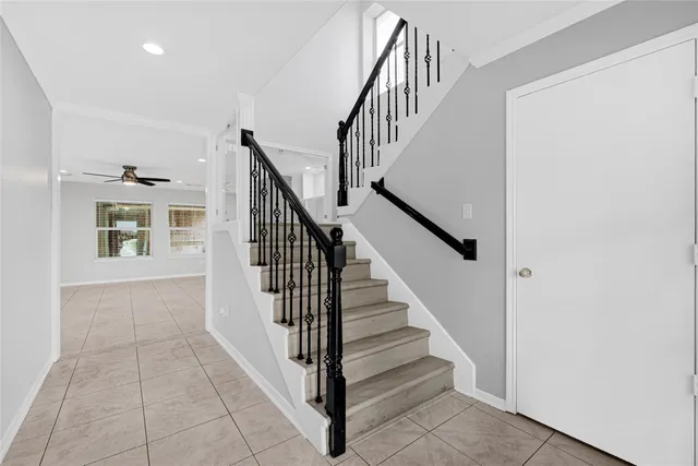 a view of staircase with wooden floor and a rug
