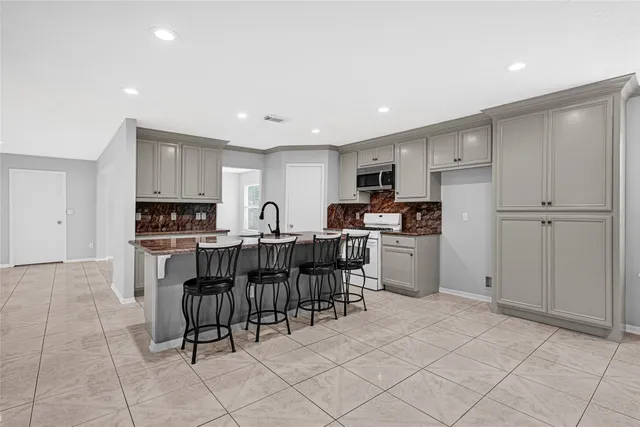 a kitchen with a refrigerator and a dining table