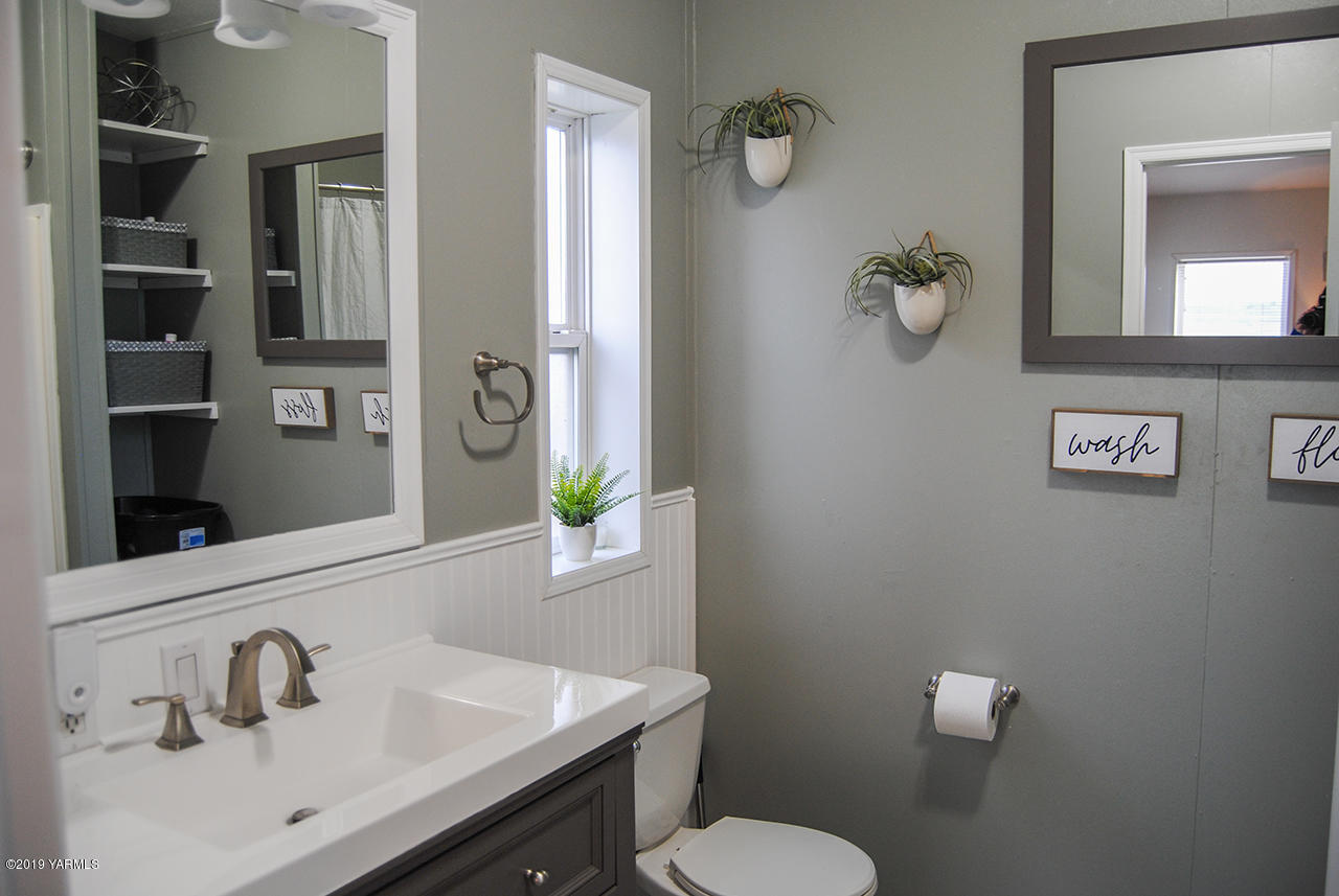 4971 Beam Road Granger, WA 98932 - Photo 9 of 24 a bathroom with a sink toilet and mirror