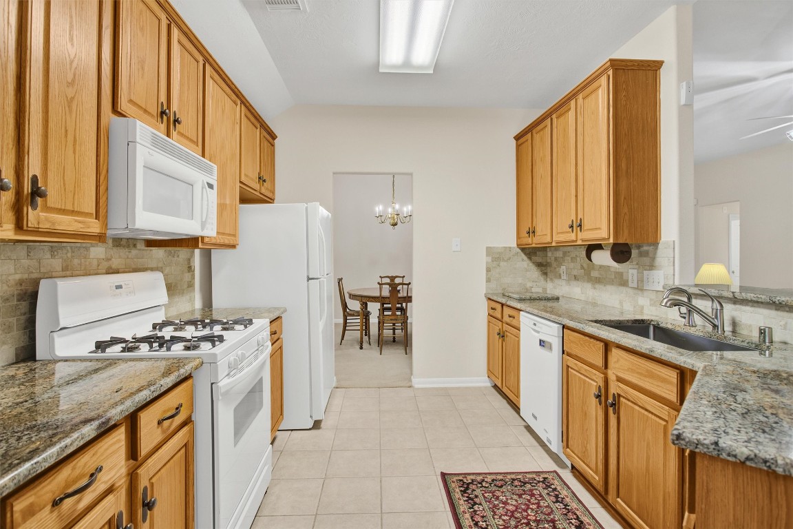6031 Skyhaven Lane Spring, TX 77379 - Photo 7 of 34 Great kitchen with granite counters and tile backsplash.