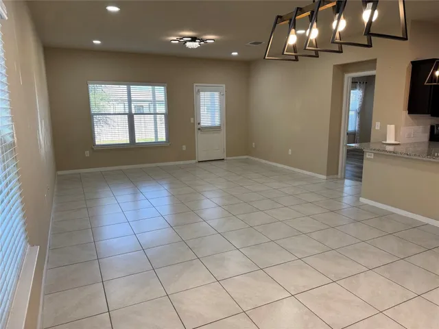 a view of a kitchen with stainless steel appliances granite countertop a sink and a microwave