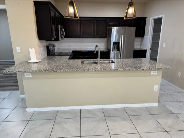 a kitchen with a sink and cabinets