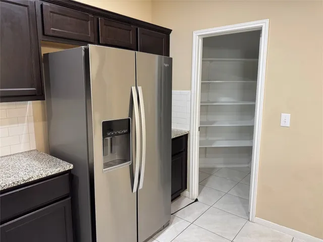 a view of an empty room with wooden floor and a cabinet