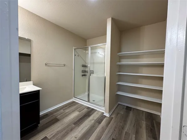a bathroom with a sink vanity and mirror