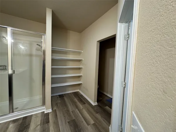 a view of a room with wooden floor
