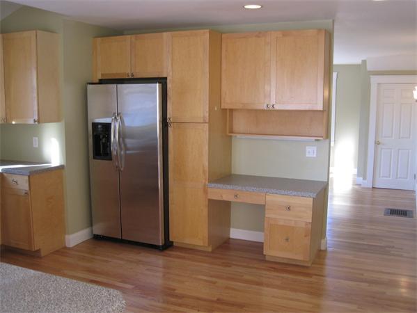 76 Ridgeway Avenue Needham, MA 02492 - Photo 7 of 20 a kitchen with stainless steel appliances a refrigerator and wooden floor