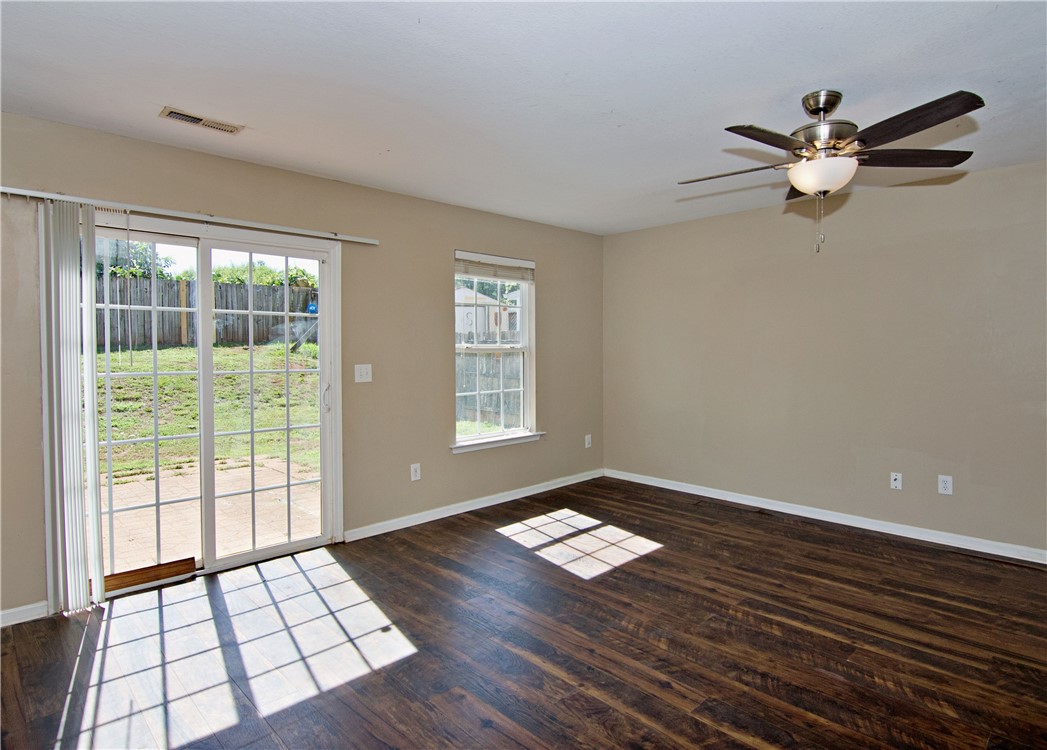 305 North Chestnut Street Seneca, SC 29678 - Photo 17 of 44 Rich hardwood floors complement neutral walls, with a spacious sliding glass door leading to the yard.