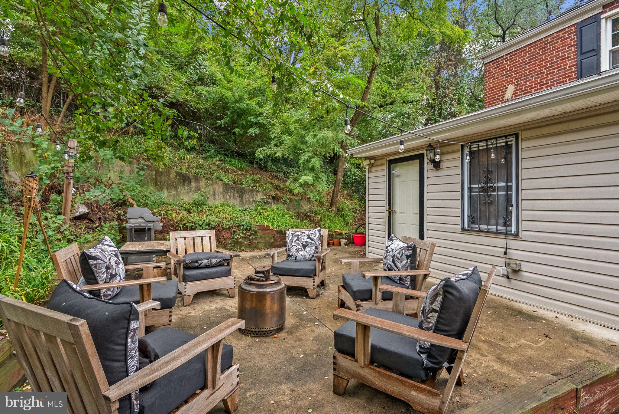 3403 Varnum Street Brentwood, MD 20722 - Photo 18 of 20 a backyard of a house with barbeque oven and outdoor seating
