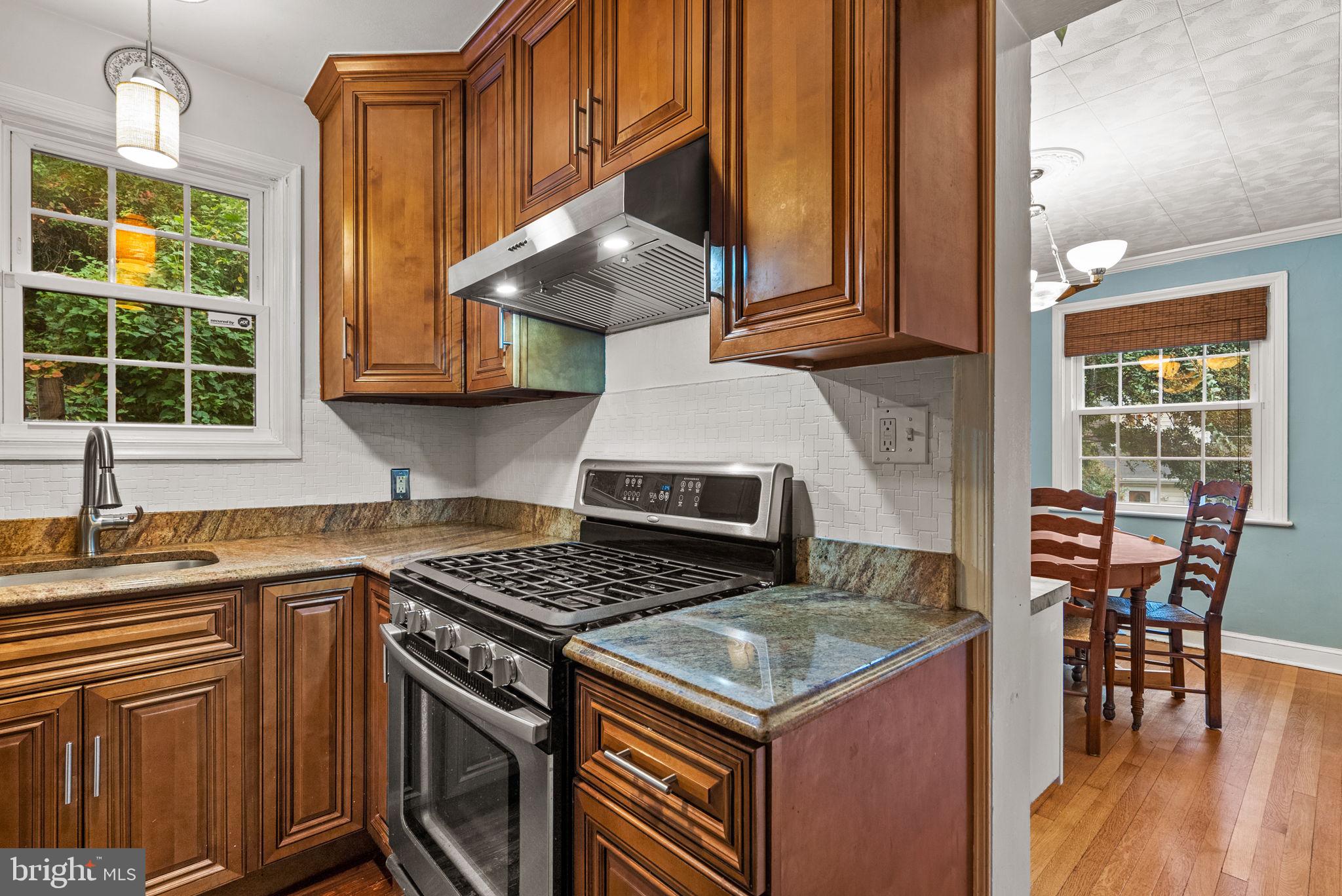 3403 Varnum Street Brentwood, MD 20722 - Photo 8 of 20 a kitchen with stainless steel appliances granite countertop a stove a sink and a microwave