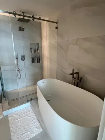 a bathroom with a bathtub and shower