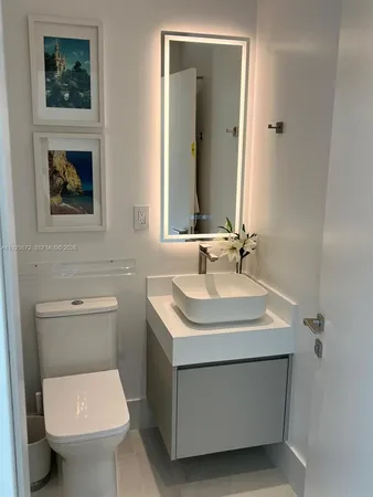 a bedroom with bed a chandelier and a couch