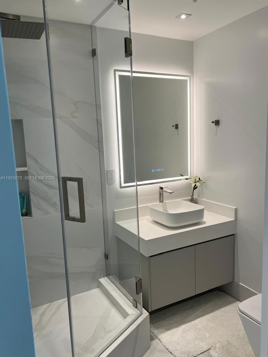 31 Southeast 5th Street, Unit 3921 Miami, FL 33131 - Photo 20 of 34 a bathroom with a sink and mirror