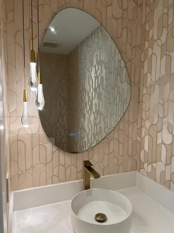 a bathroom with a sink and mirror