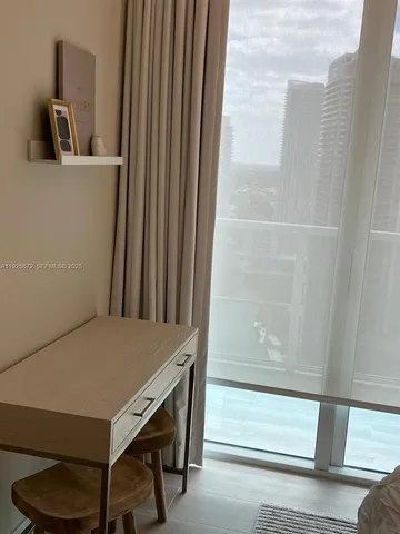 a bedroom with a bed and chandelier