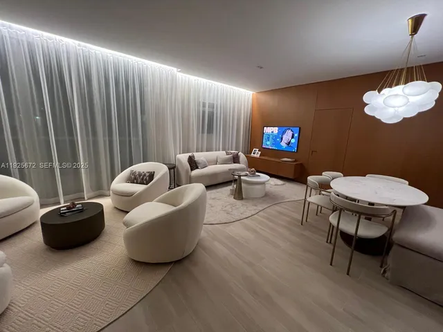 a living room with furniture a rug and a chair