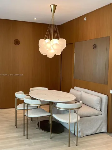 a view of a dining room with a table and chairs