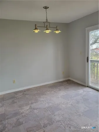 a view of empty room with ceiling fan