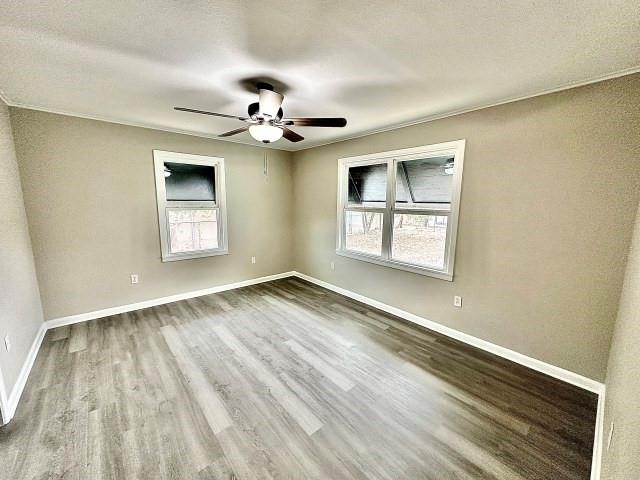 415 Hendrickson Street Goldsmith, TX 79741 - Photo 16 of 17 a view of an empty room with a window and wooden floor