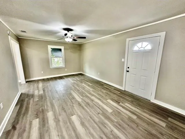 wooden floor in an empty room with a window