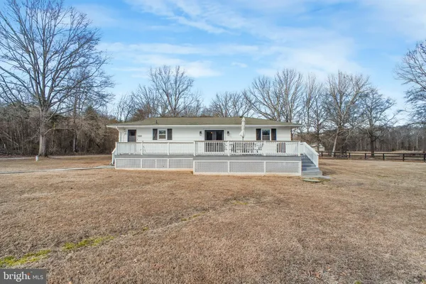 a front view of house with yard and trees