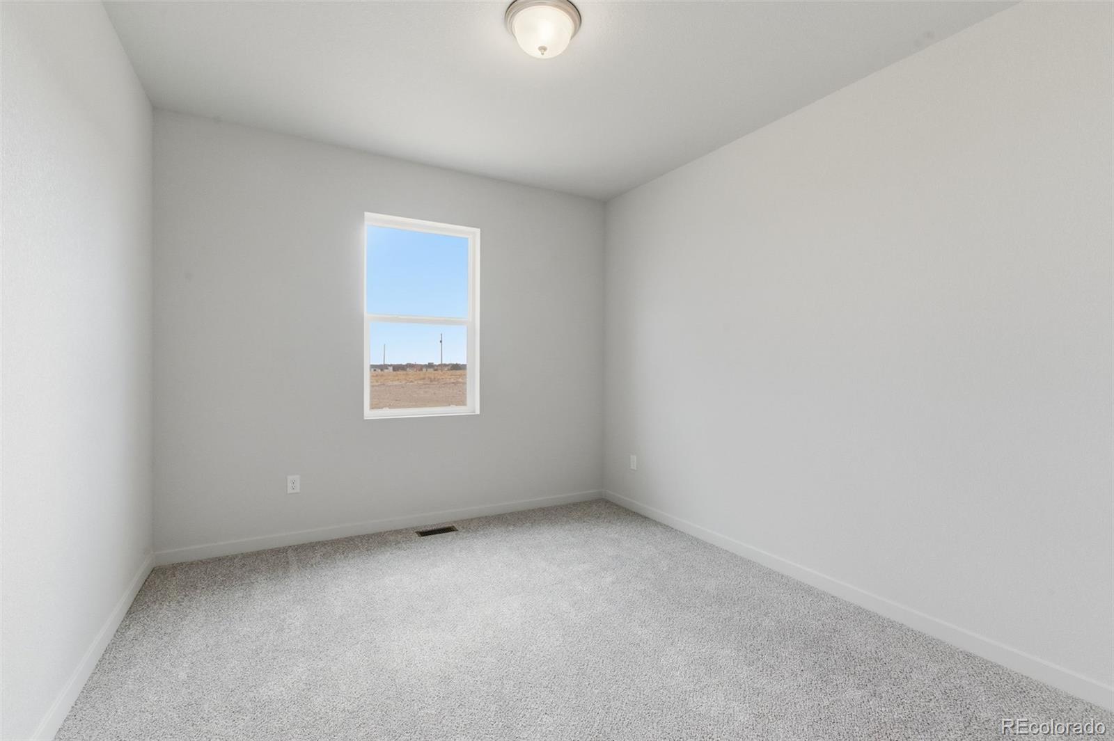24615 Big Springs Road Pueblo West, CO 81007 - Photo 12 of 24 a view of an empty room with a window