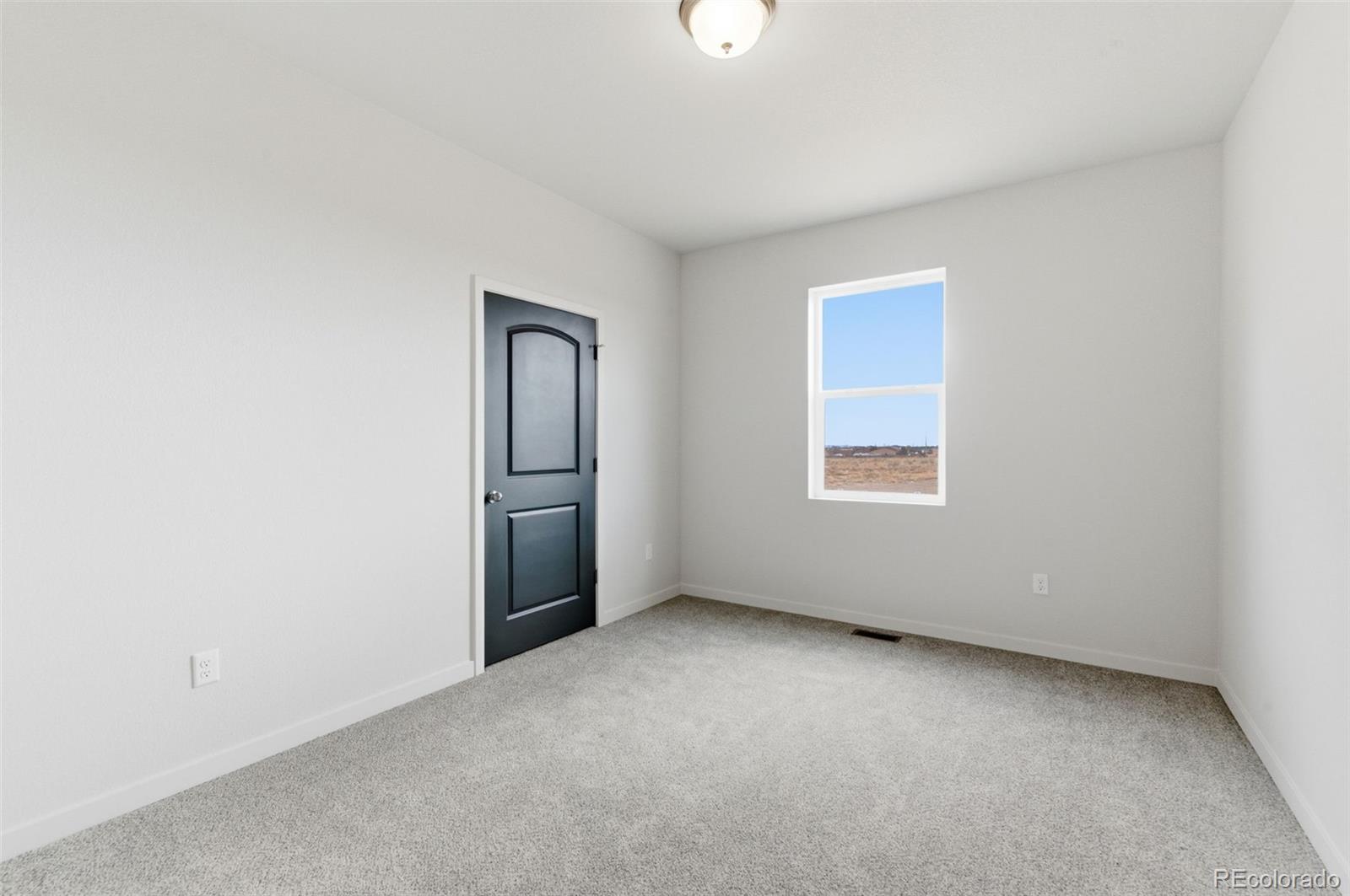 24615 Big Springs Road Pueblo West, CO 81007 - Photo 14 of 24 an empty room with windows and closet