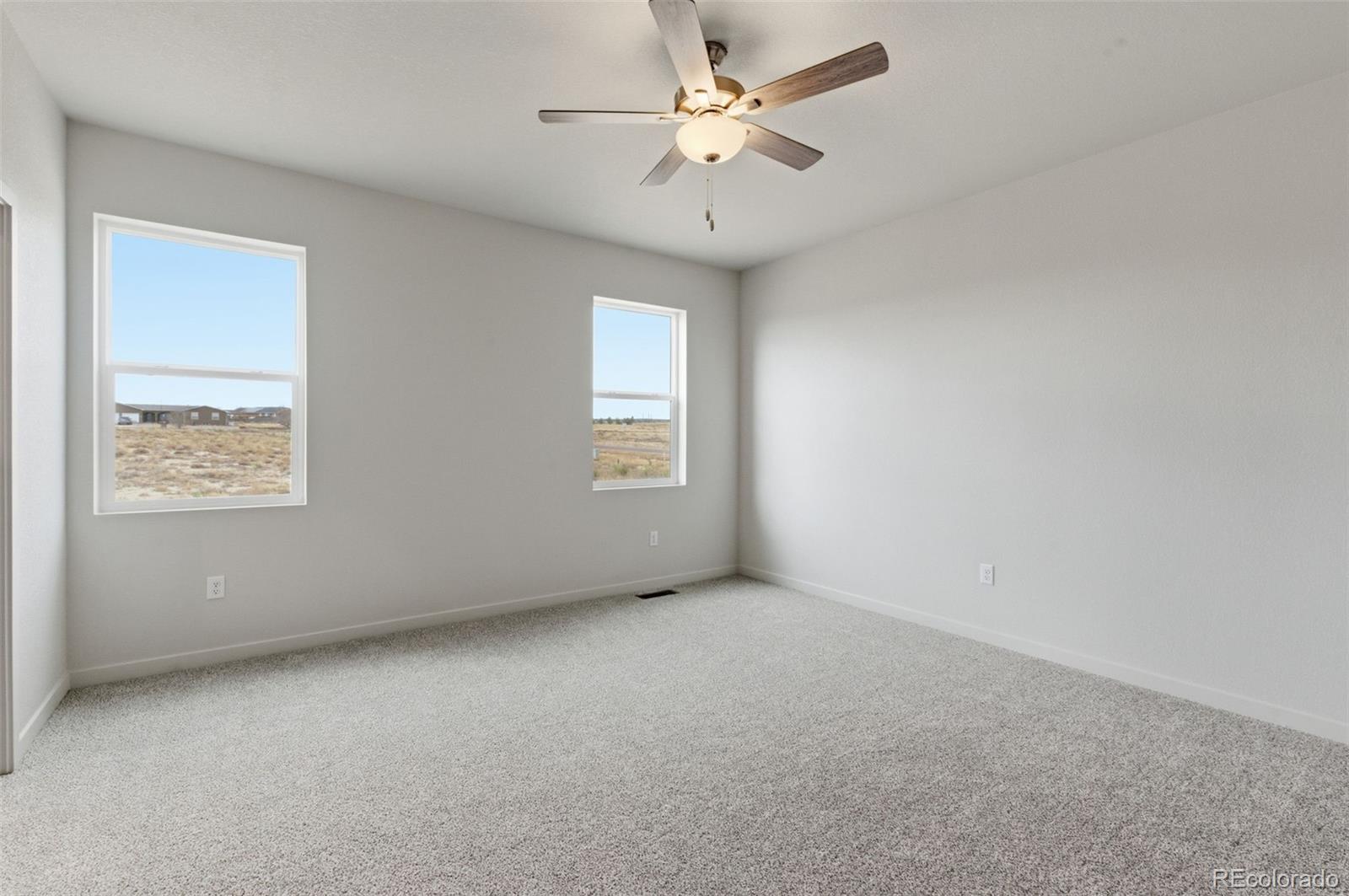 24615 Big Springs Road Pueblo West, CO 81007 - Photo 17 of 24 an empty room with a window and a fan
