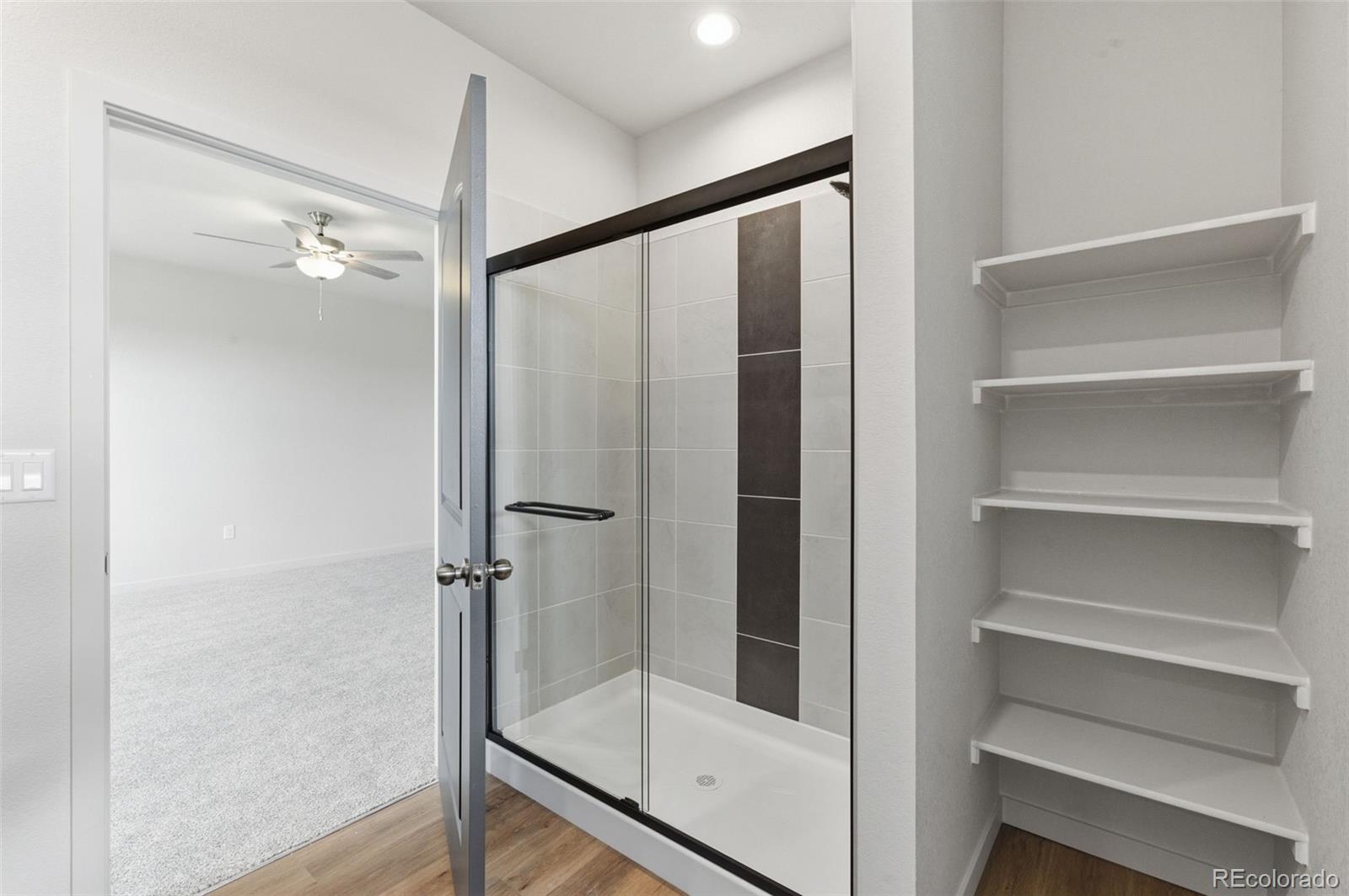 24615 Big Springs Road Pueblo West, CO 81007 - Photo 22 of 24 a bathroom with a glass shower door