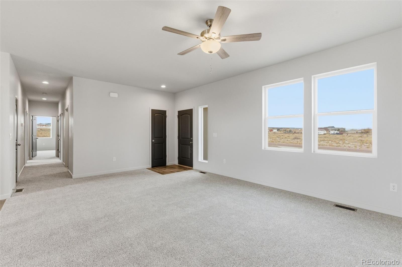 24615 Big Springs Road Pueblo West, CO 81007 - Photo 4 of 24 an empty room with fan and windows