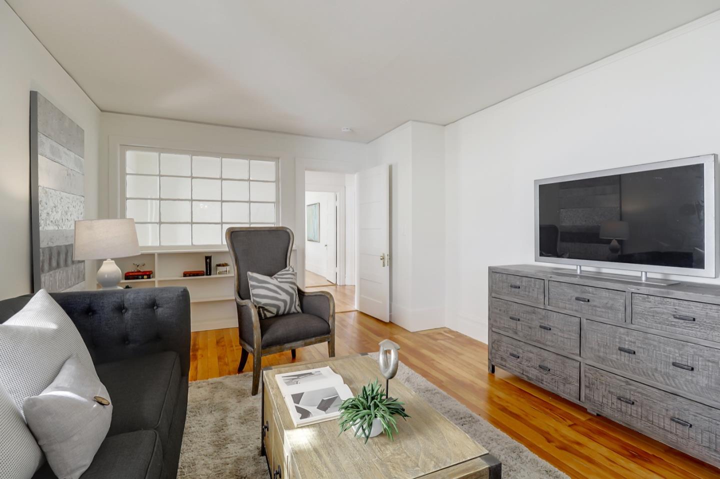 2614 Etna Street Berkeley, CA 94704 - Photo 25 of 59 a living room with furniture and a flat screen tv