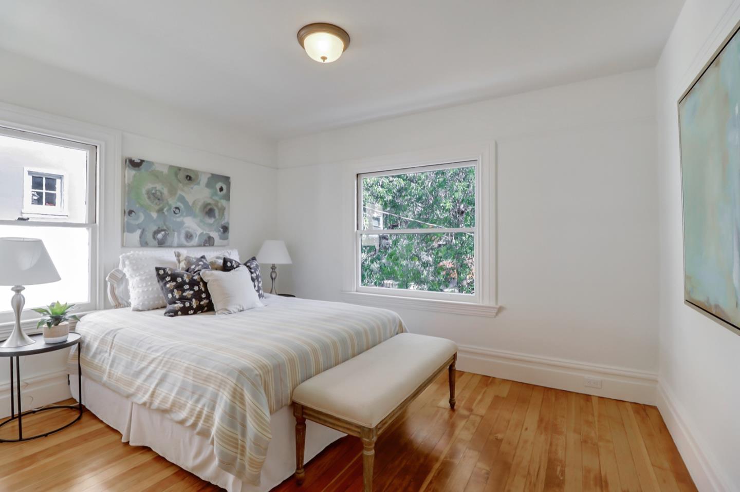 2614 Etna Street Berkeley, CA 94704 - Photo 26 of 59 a bedroom with a bed and wooden floor