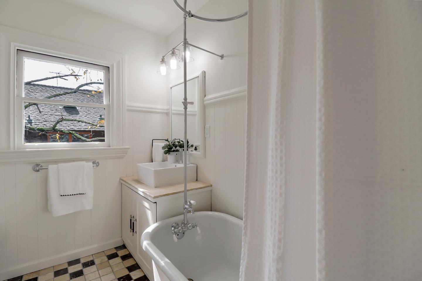 2614 Etna Street Berkeley, CA 94704 - Photo 34 of 59 a bathroom with a sink a mirror and a shower