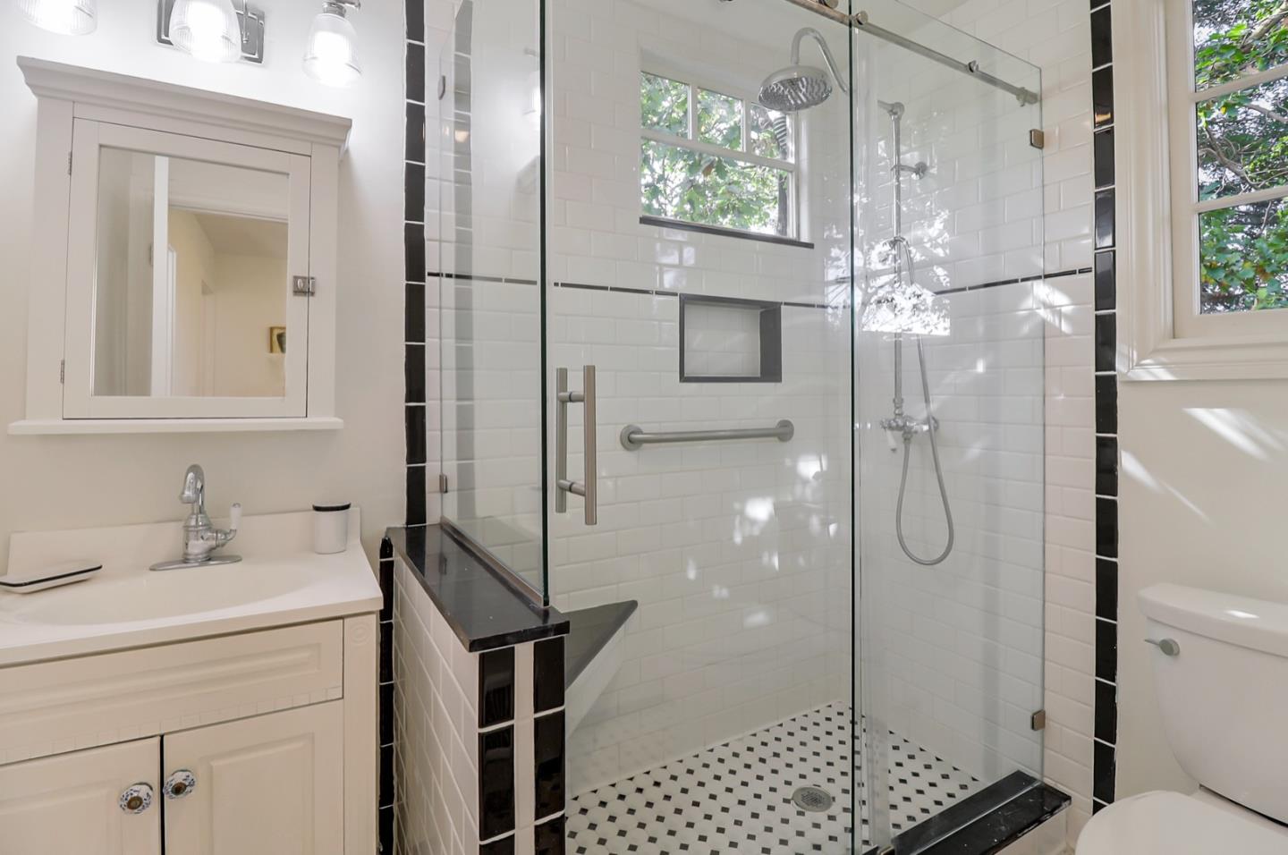 2614 Etna Street Berkeley, CA 94704 - Photo 35 of 59 a bathroom with a shower a mirror and a sink