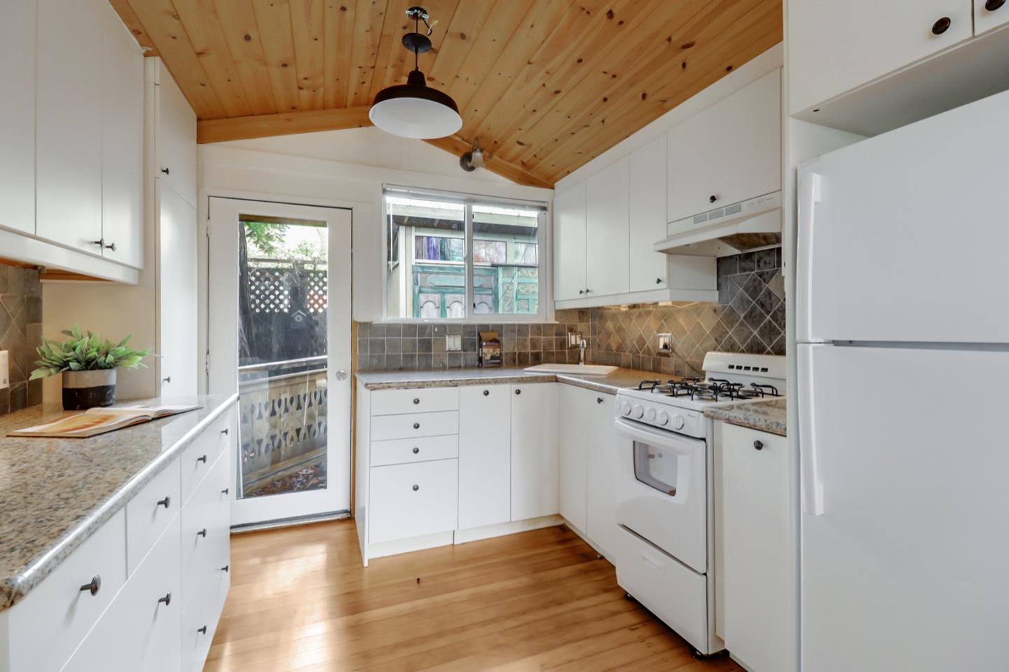 2614 Etna Street Berkeley, CA 94704 - Photo 42 of 59 a kitchen with granite countertop cabinets stainless steel appliances and a counter space