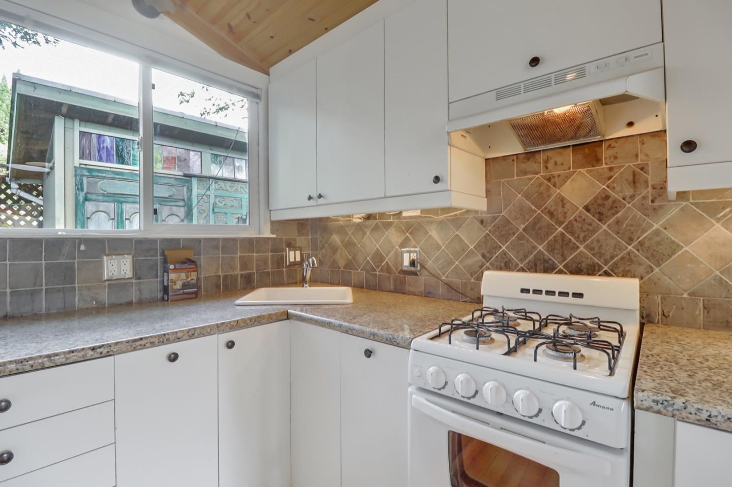 2614 Etna Street Berkeley, CA 94704 - Photo 44 of 59 a kitchen with a stove and white cabinets