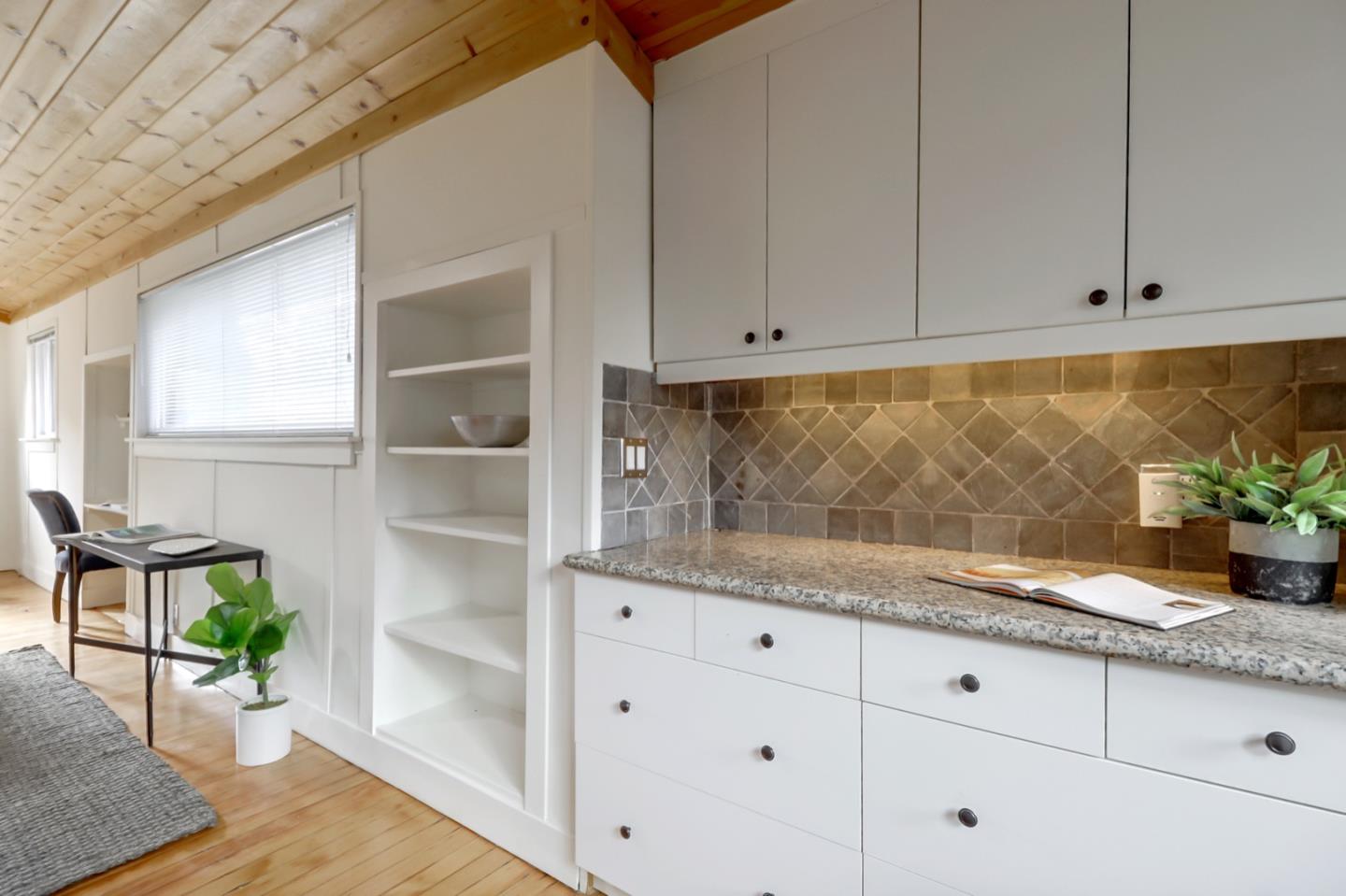 2614 Etna Street Berkeley, CA 94704 - Photo 45 of 59 a kitchen with granite countertop white cabinets and wooden floor