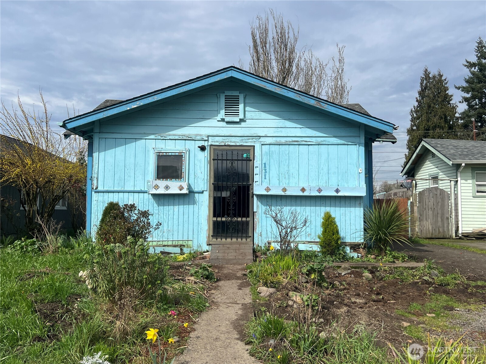 a front view of a house with garden