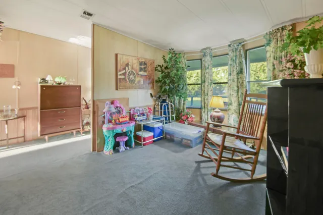 a view of a dining room with furniture window and outside view