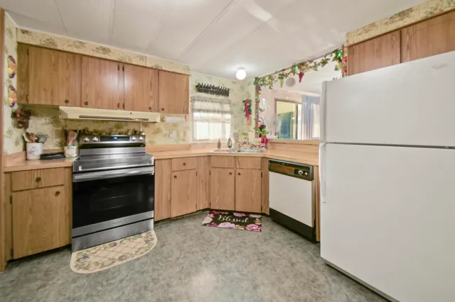 a kitchen with granite countertop cabinets and black appliances