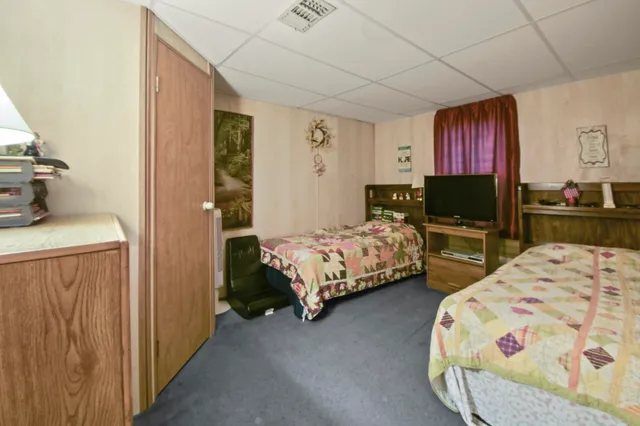 a bedroom with a bed and a painting on the wall